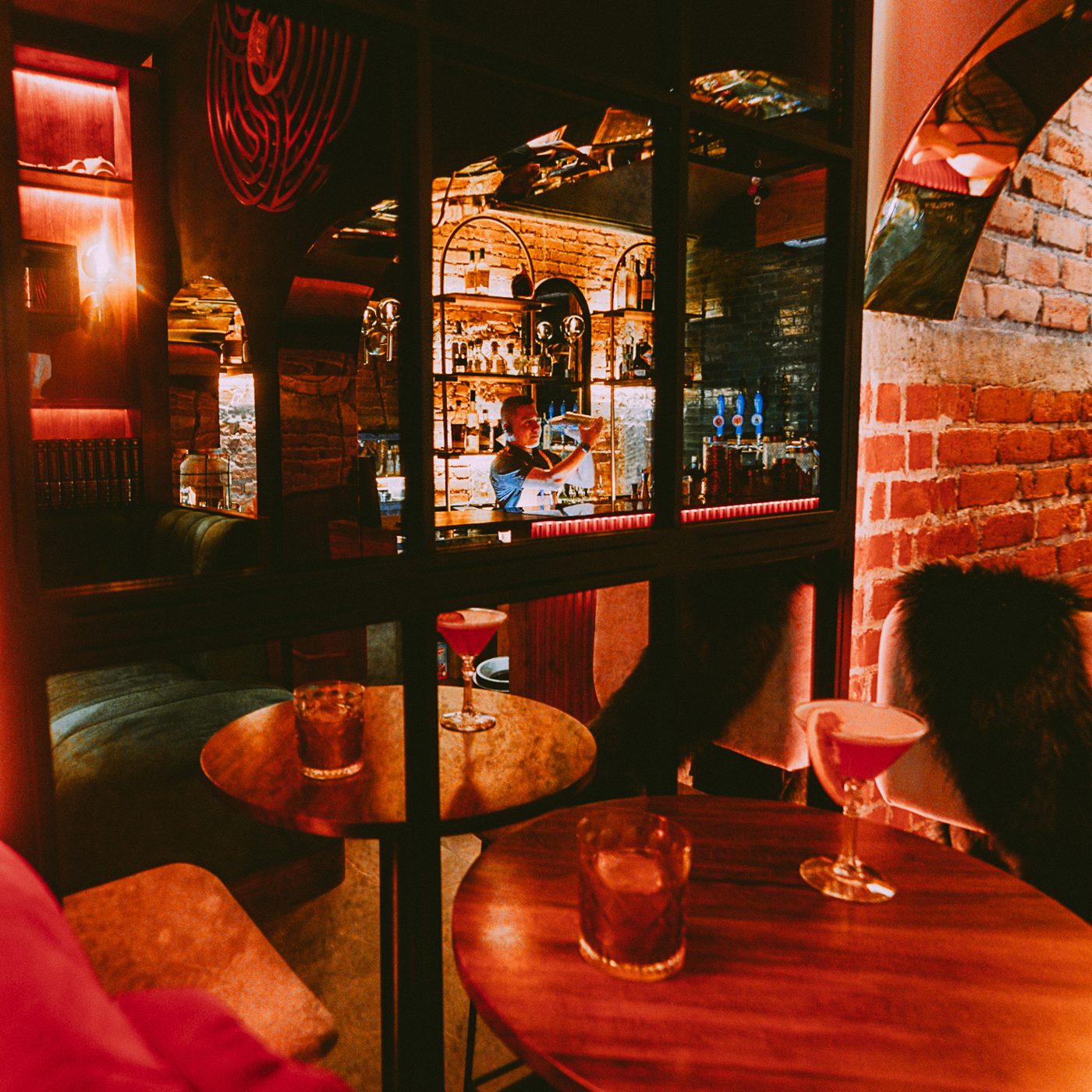 Inside Wisdom — brick arches and cocktails in warm light