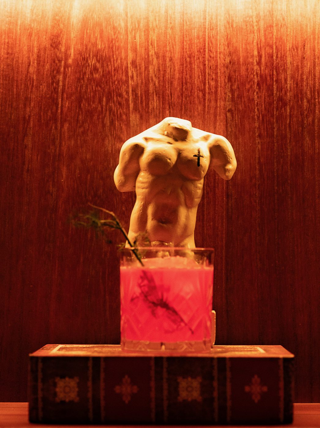 Wisdom details — sculpture and a red cocktail